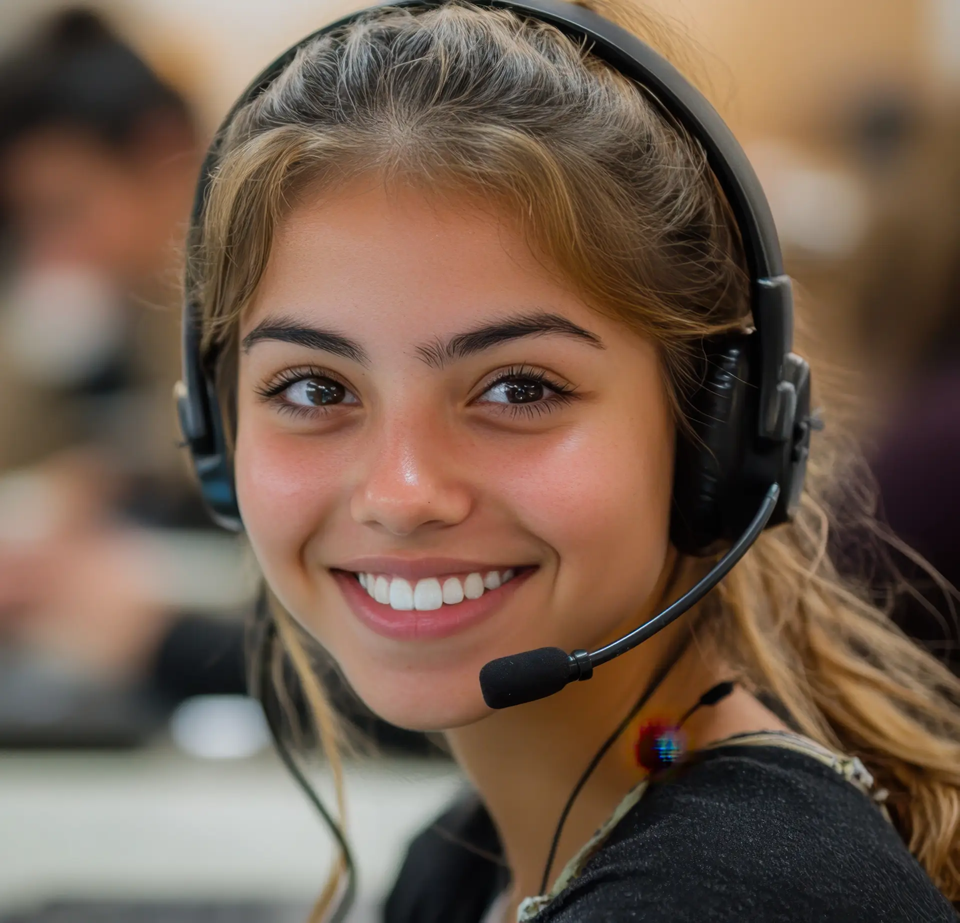 Smiling female receptionist wearing a headset, representing Ascendea's AI agents for customer interactions and appointment management.